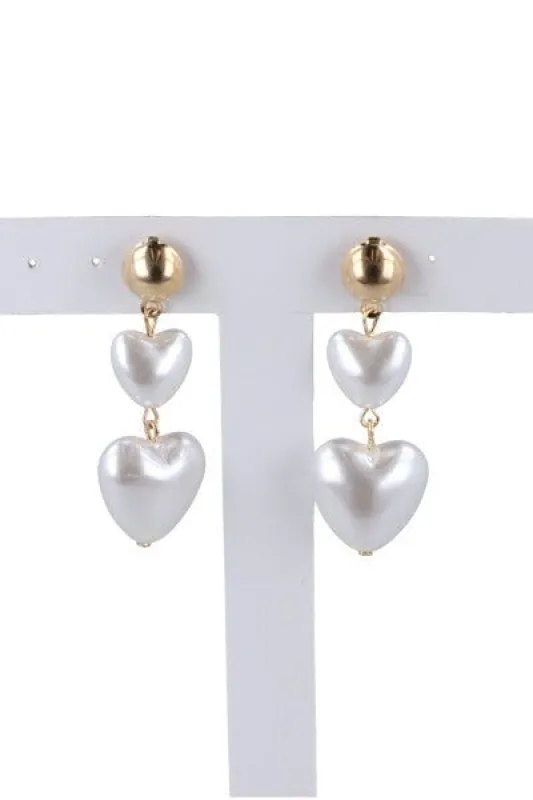 Aretes largos perla corazón sold by Shasa