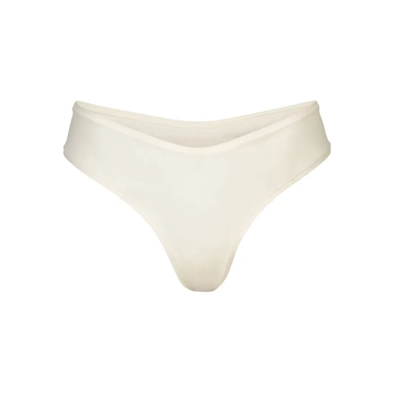 COTTON JERSEY DIPPED THONG | BONE sold by SKIMS