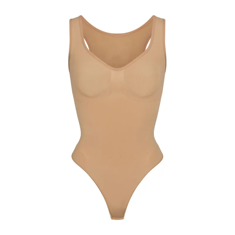 SEAMLESS SCULPT SCOOP NECK THONG BODYSUIT | OCHRE sold by SKIMS