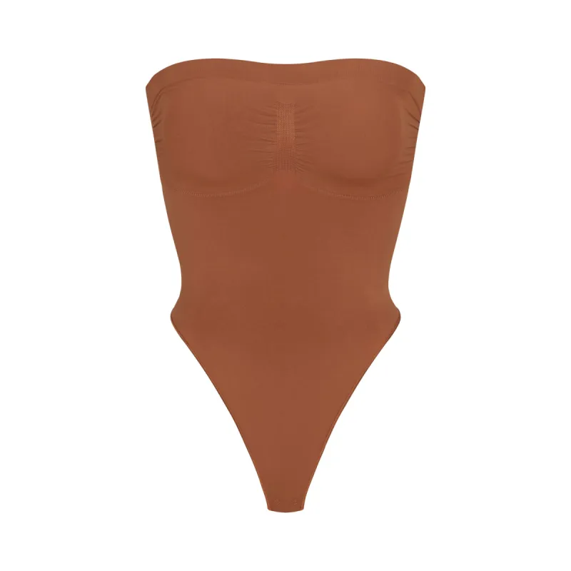 SEAMLESS SCULPT STRAPLESS THONG BODYSUIT | BRONZE sold by SKIMS