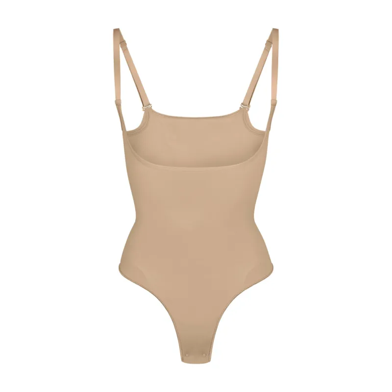 SEAMLESS SCULPT OPEN BUST THONG BODYSUIT | CLAY sold by SKIMS