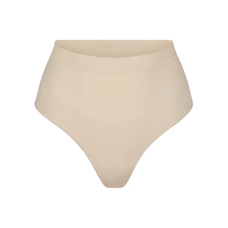 SEAMLESS SCULPT MID WAIST THONG | SAND sold by SKIMS
