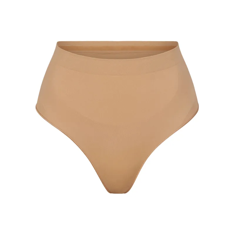SEAMLESS SCULPT MID WAIST THONG | OCHRE sold by SKIMS