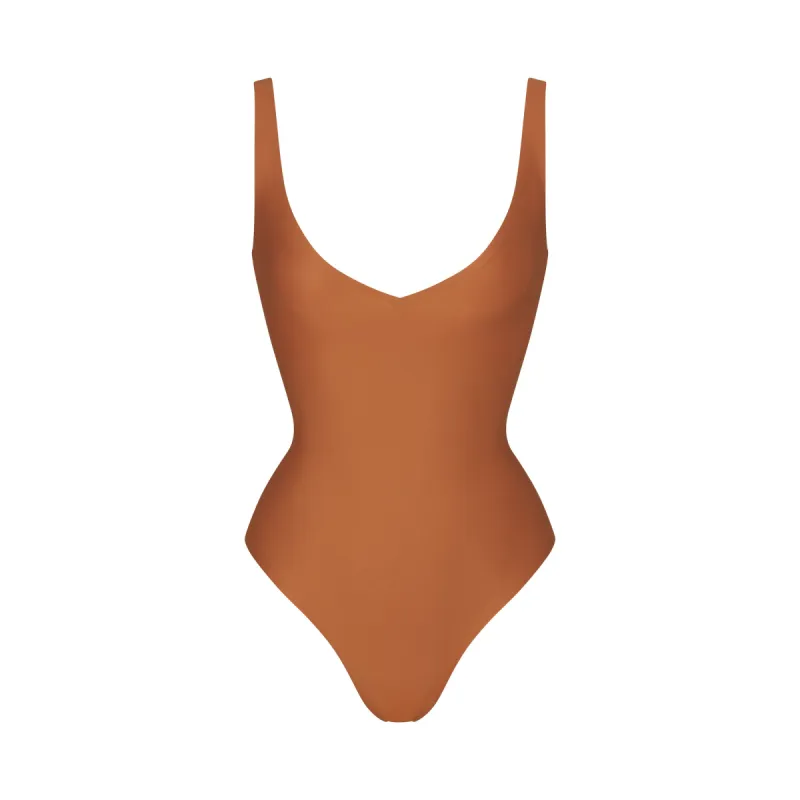SKIMS BODY UNLINED PLUNGE THONG BODYSUIT | BRONZE sold by SKIMS