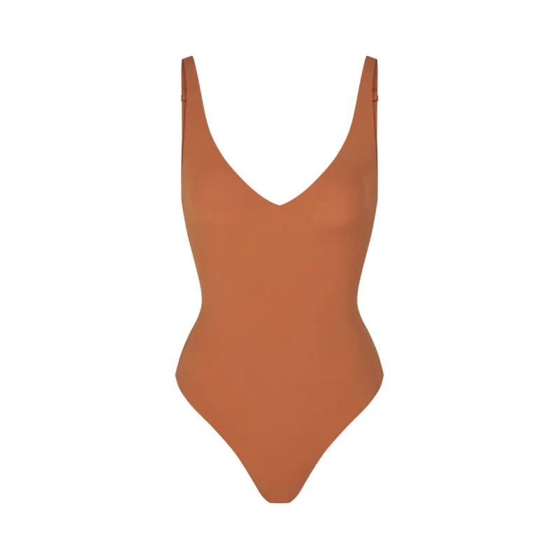 NAKED PLUNGE THONG BODYSUIT | BRONZE sold by SKIMS