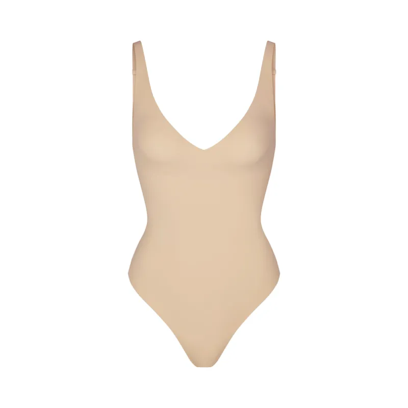NAKED PLUNGE THONG BODYSUIT | SAND sold by SKIMS