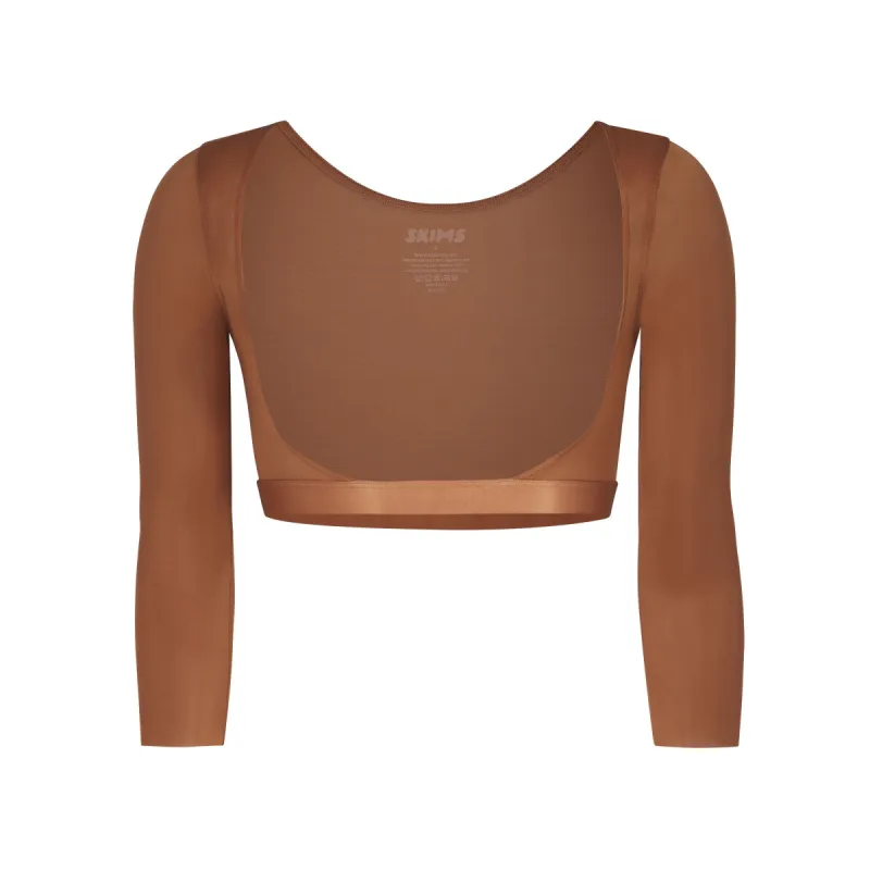 SIMPLY BARE OPEN BUST ARM SHAPER | BRONZE sold by SKIMS