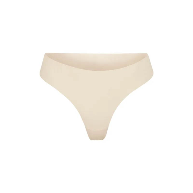 NAKED DIPPED THONG | SAND sold by SKIMS