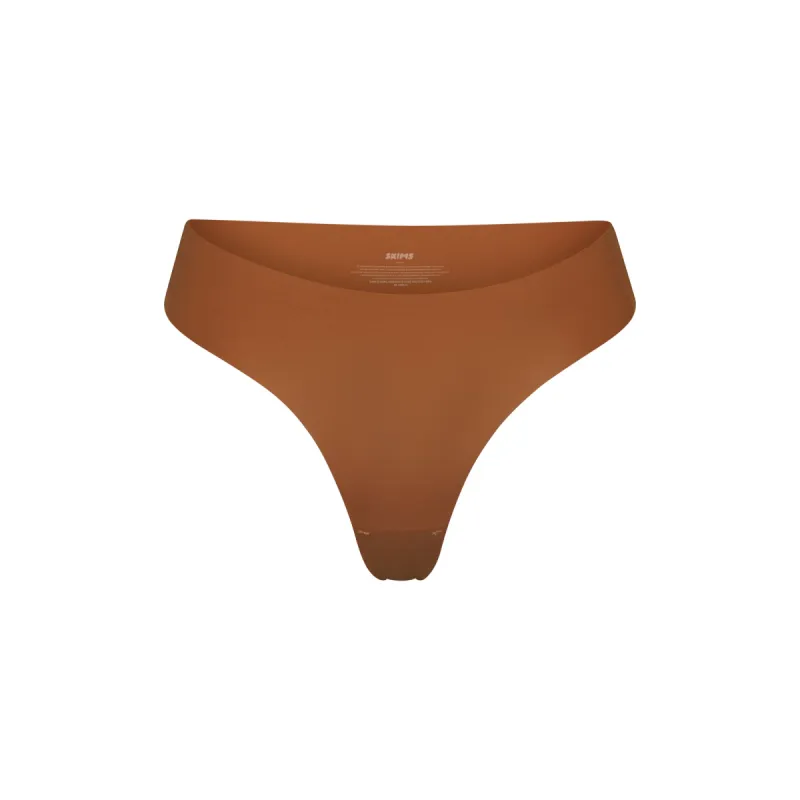NAKED DIPPED THONG | BRONZE sold by SKIMS