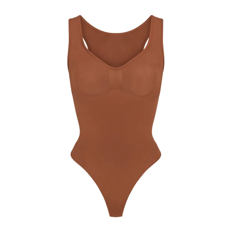 SEAMLESS SCULPT SCOOP NECK THONG BODYSUIT | BRONZE sold by SKIMS