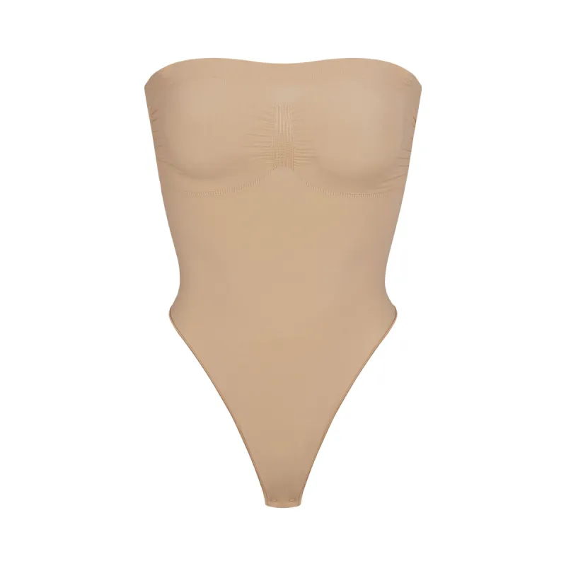 SEAMLESS SCULPT STRAPLESS THONG BODYSUIT | CLAY sold by SKIMS