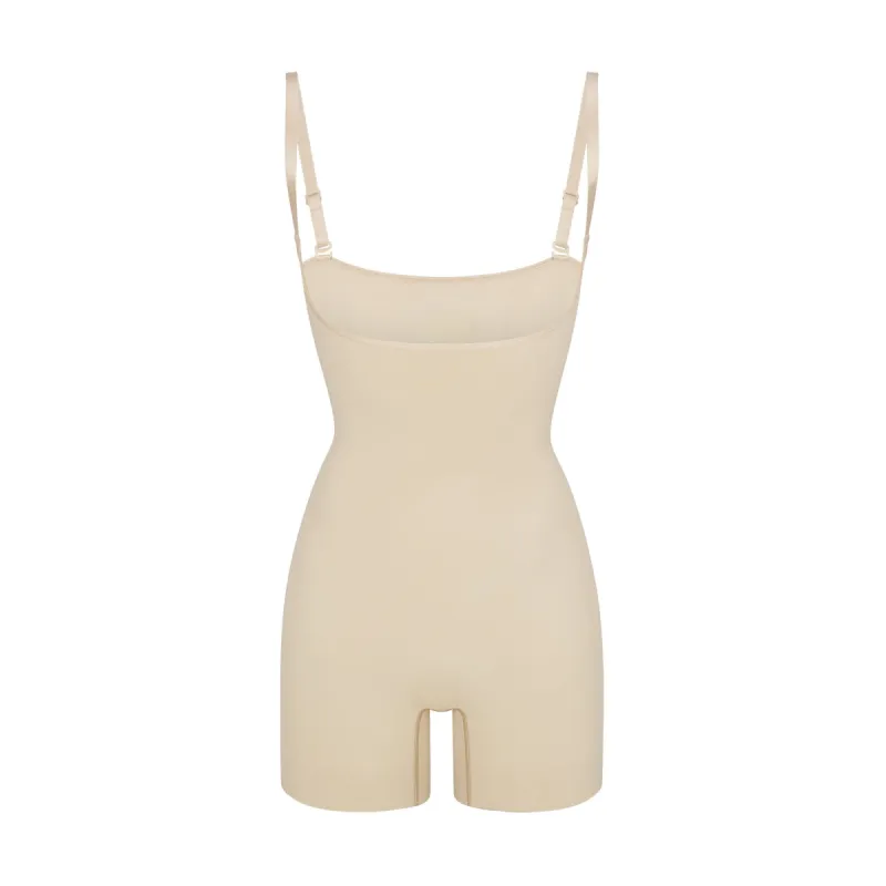 SEAMLESS SCULPT OPEN BUST SHORTIE BODYSUIT | SAND sold by SKIMS