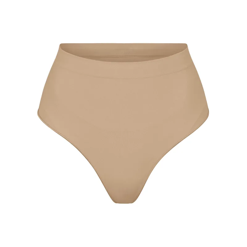 SEAMLESS SCULPT MID WAIST THONG | CLAY sold by SKIMS