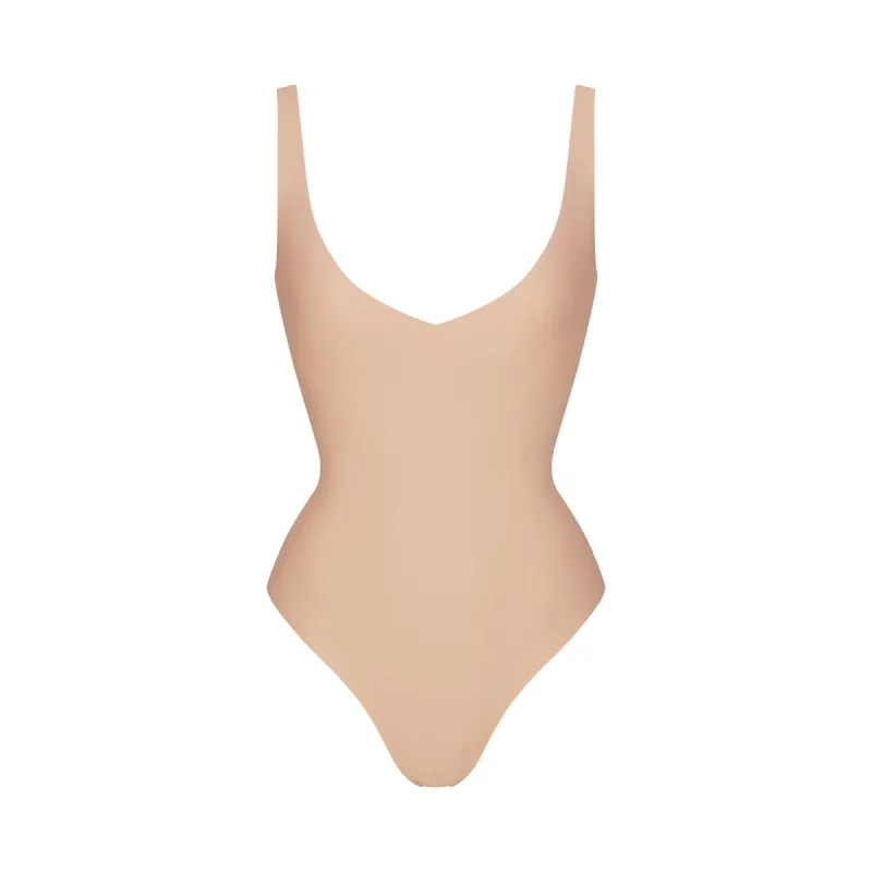 SKIMS BODY UNLINED PLUNGE THONG BODYSUIT | CLAY sold by SKIMS