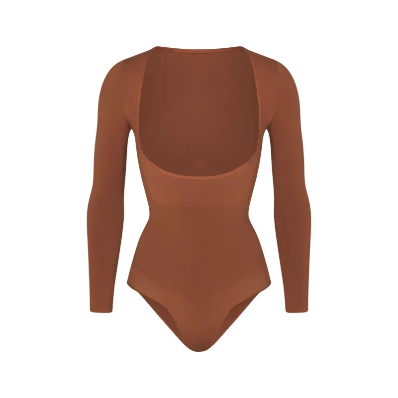 SEAMLESS SCULPT LONG SLEEVE OPEN BUST BRIEF BODYSUIT | BRONZE sold by SKIMS