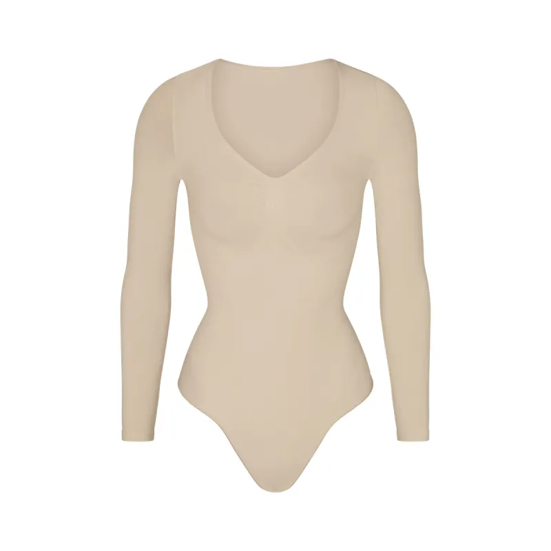 SEAMLESS SCULPT LONG SLEEVE THONG BODYSUIT | SAND sold by SKIMS