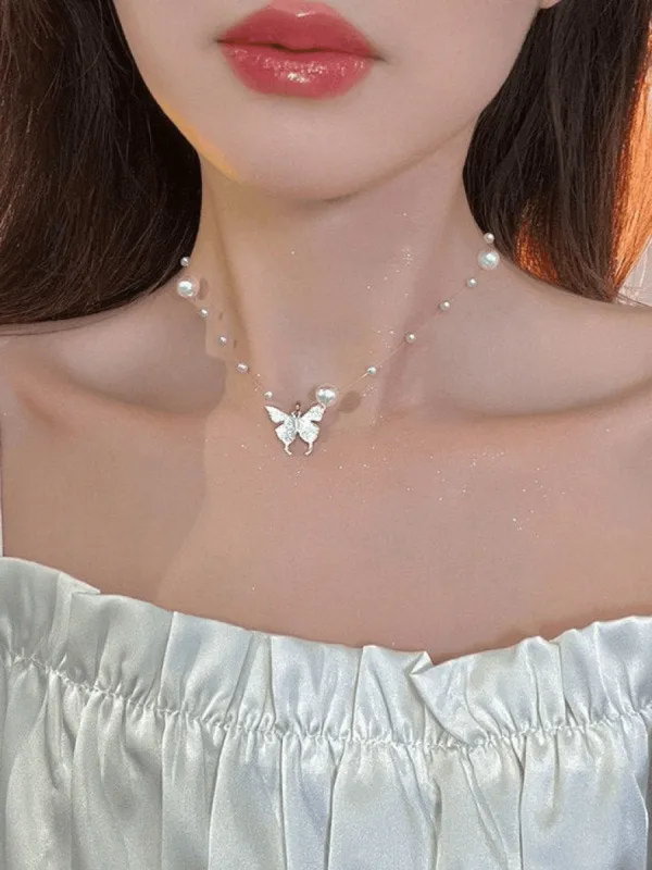 Faux pearl necklace with butterfly charm sold by Streetwear Society