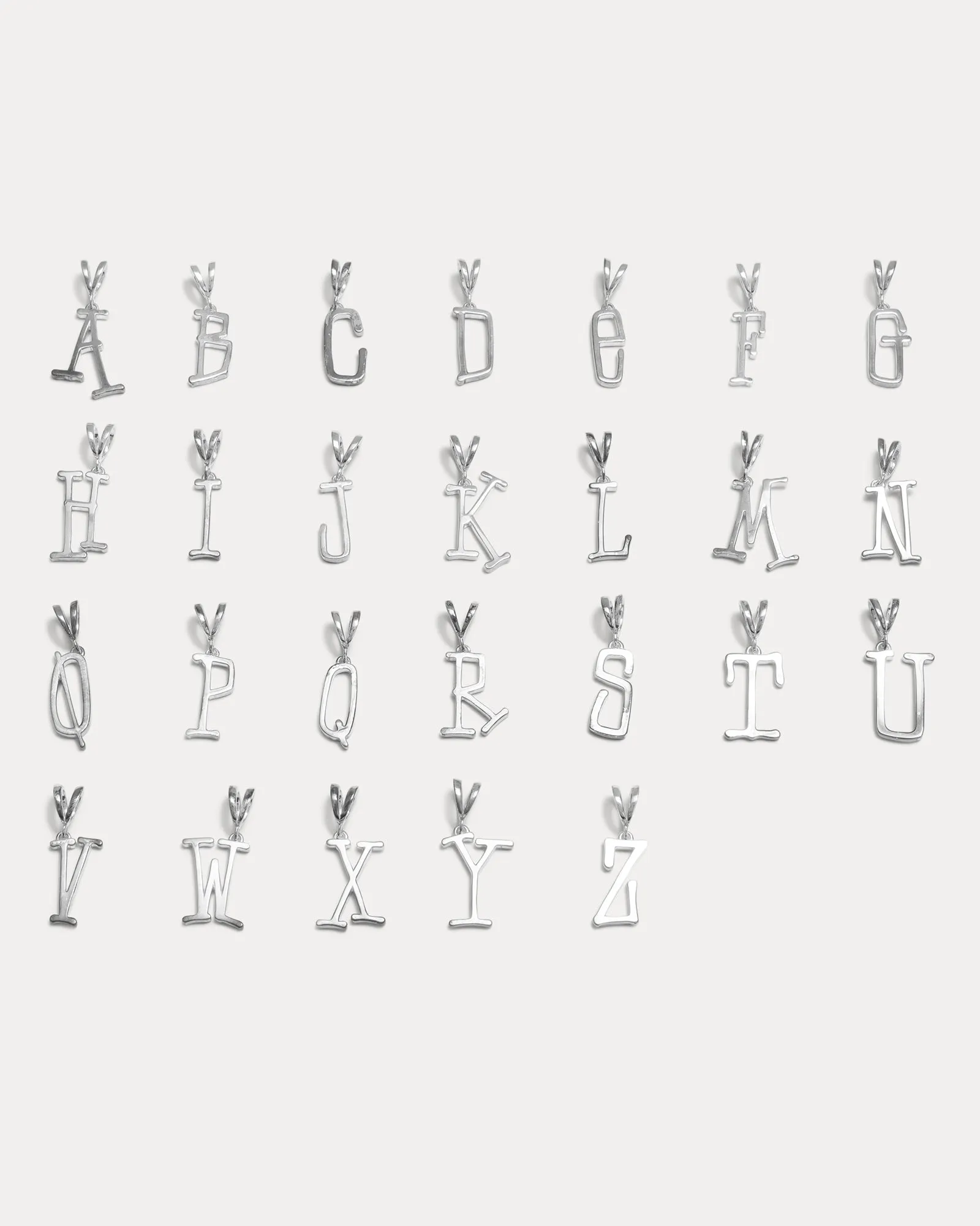 SILVER ALPHABET PENDANT sold by Stussy