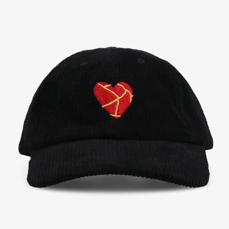 Take Care Heart Corduroy Hat in Black sold by Taft