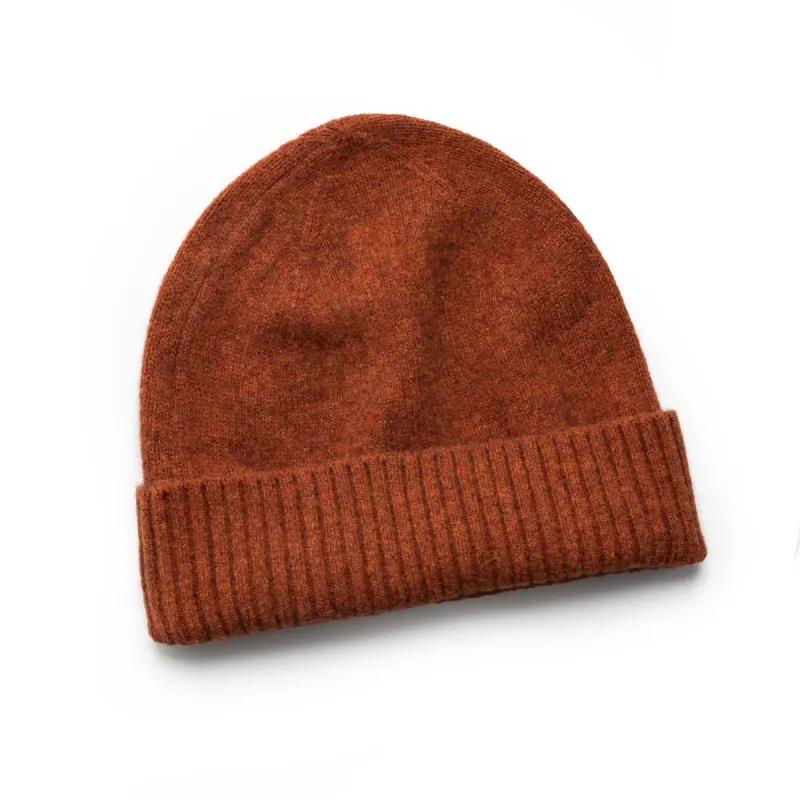The Lodge Beanie in Rust sold by Taylor Stitch
