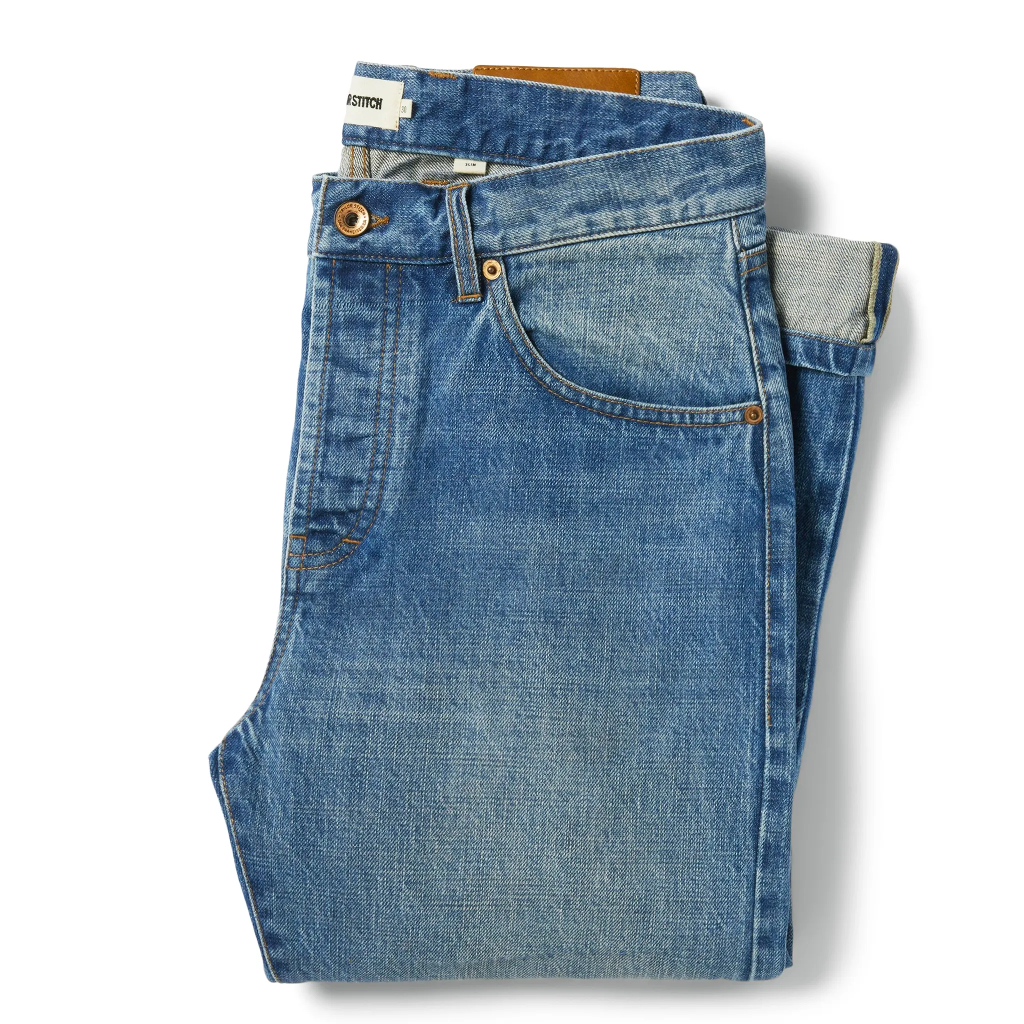 The Slim Jean in Patch Wash Selvage sold by Taylor Stitch