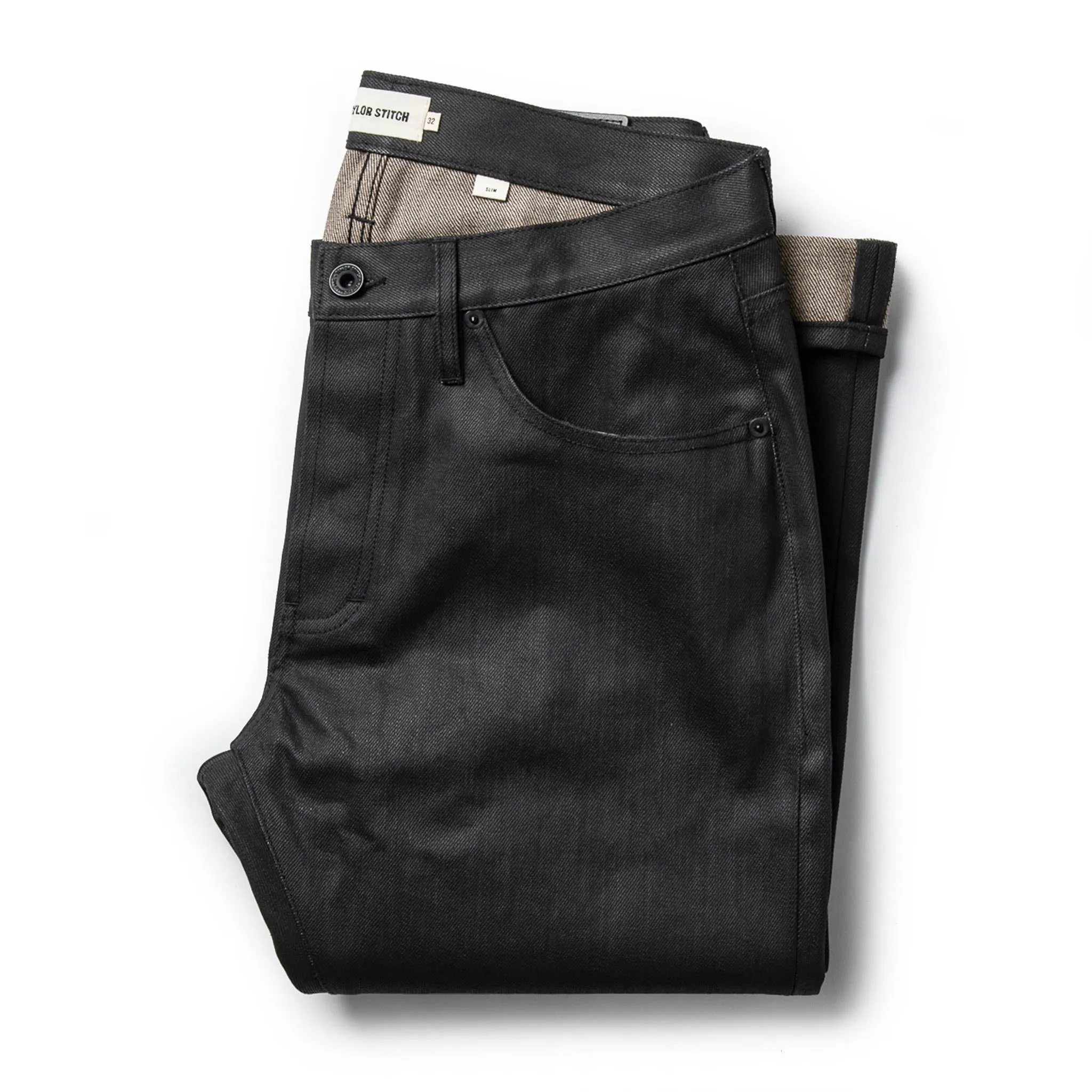 The Slim Jean in Black Over-dye Selvage sold by Taylor Stitch