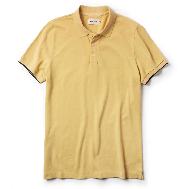 The Pique Polo in Straw sold by Taylor Stitch