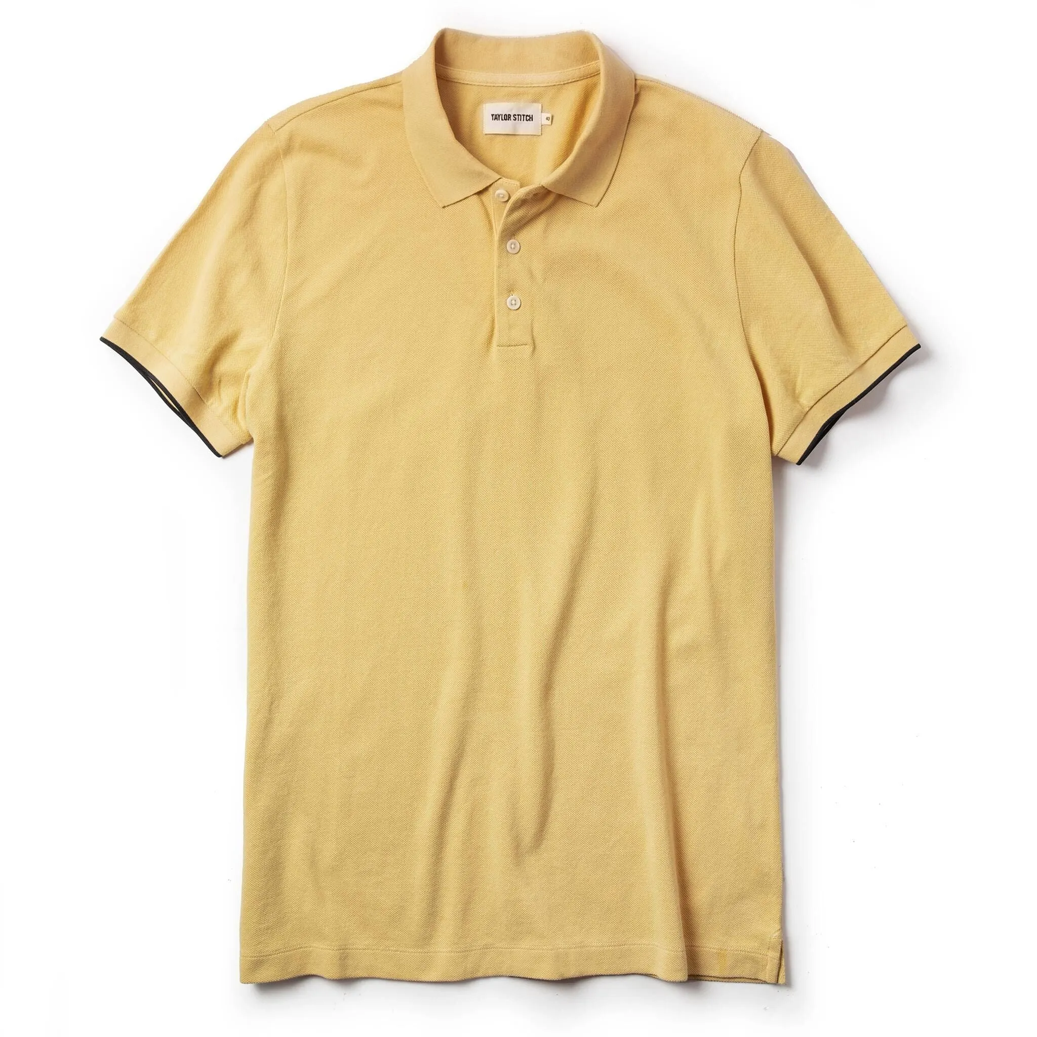 The Pique Polo in Straw sold by Taylor Stitch