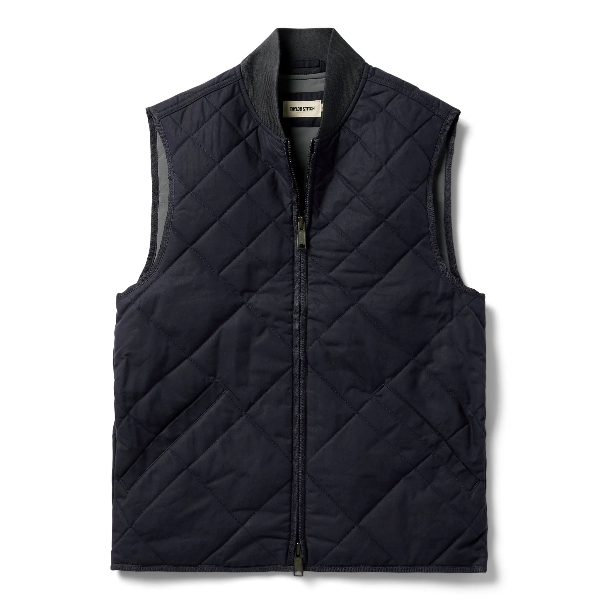 The Quilted Bomber Vest in Navy Dry Wax sold by Taylor Stitch