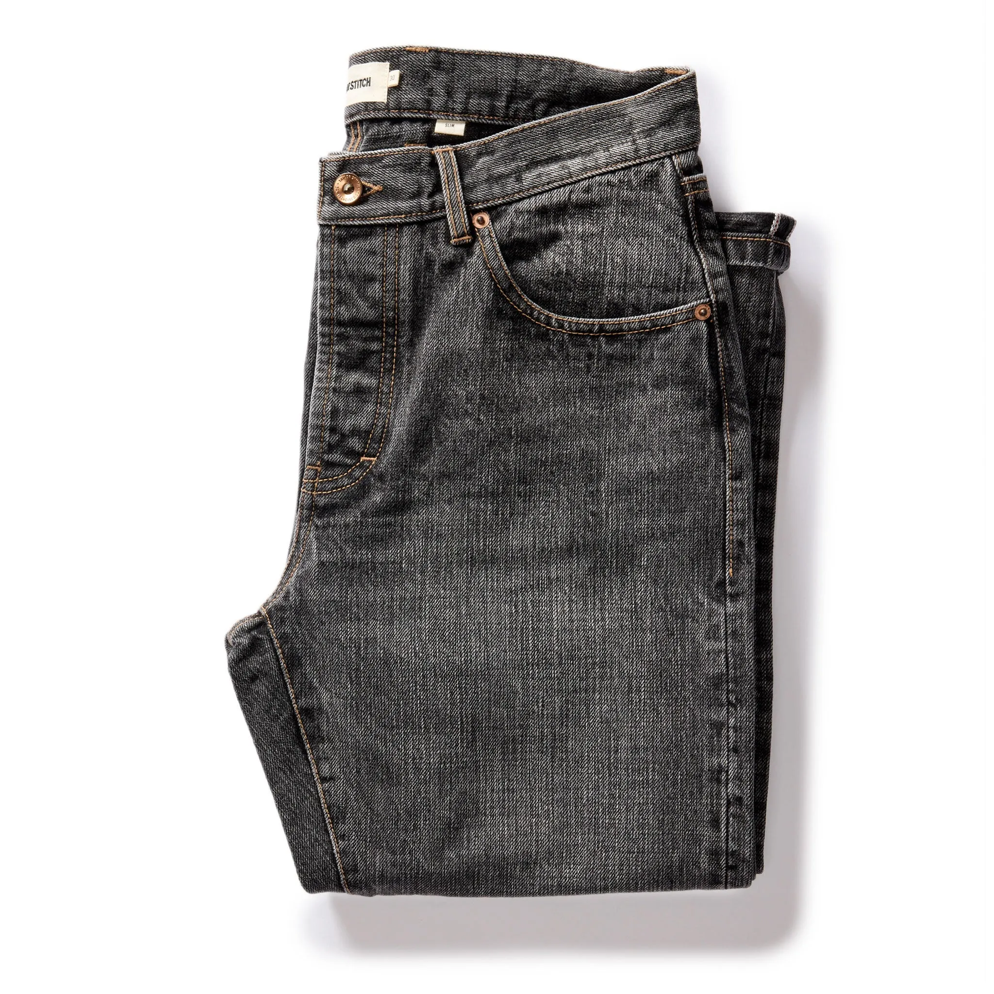 The Slim Jean in Black 1-Year Wash Selvage Denim sold by Taylor Stitch