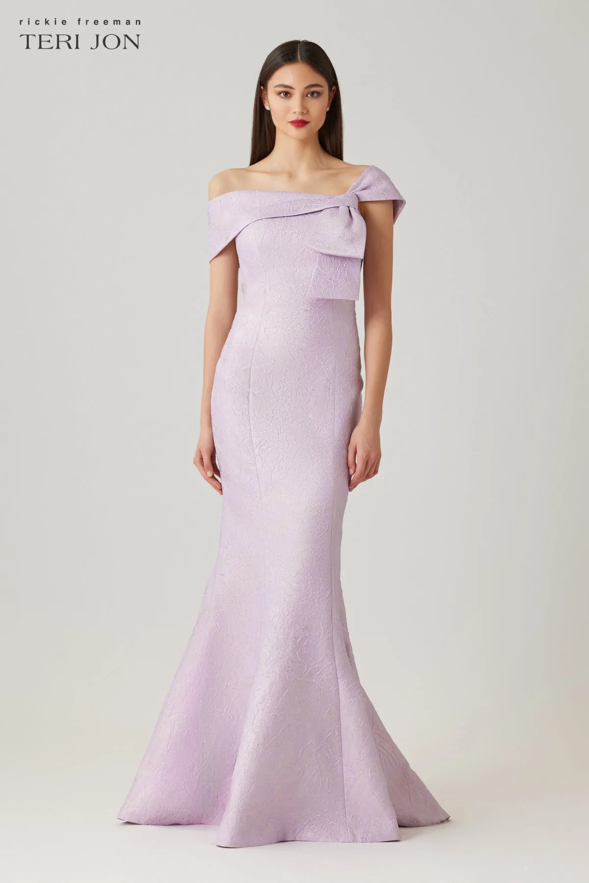 Jacquard Asymmetrical Off The Shoulder Side Bow Godet Gown sold by Teri Jon