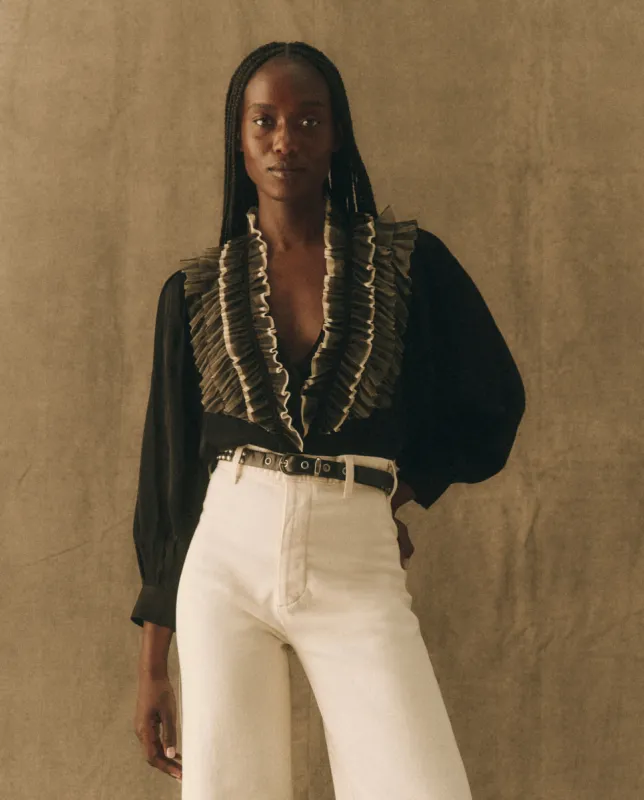 The Ruffled Tuxedo Top. -- Black with Cream sold by THE GREAT.