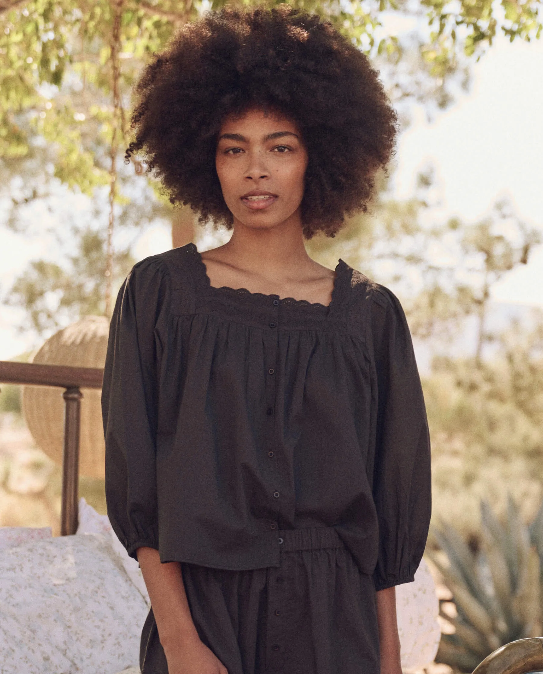 The Eyelet Button Sleep Top. -- Black sold by THE GREAT.