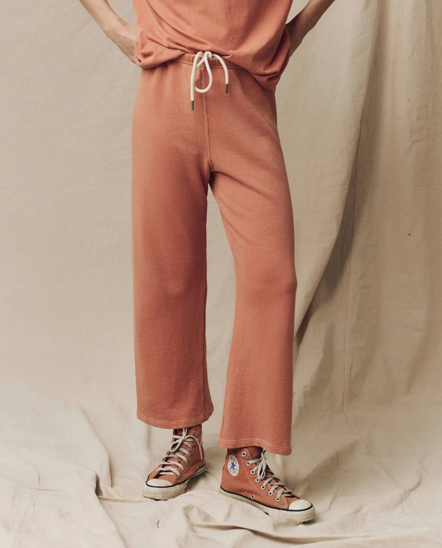 The Lap Sweatpant. Solid -- Sun Dried Orange sold by THE GREAT.