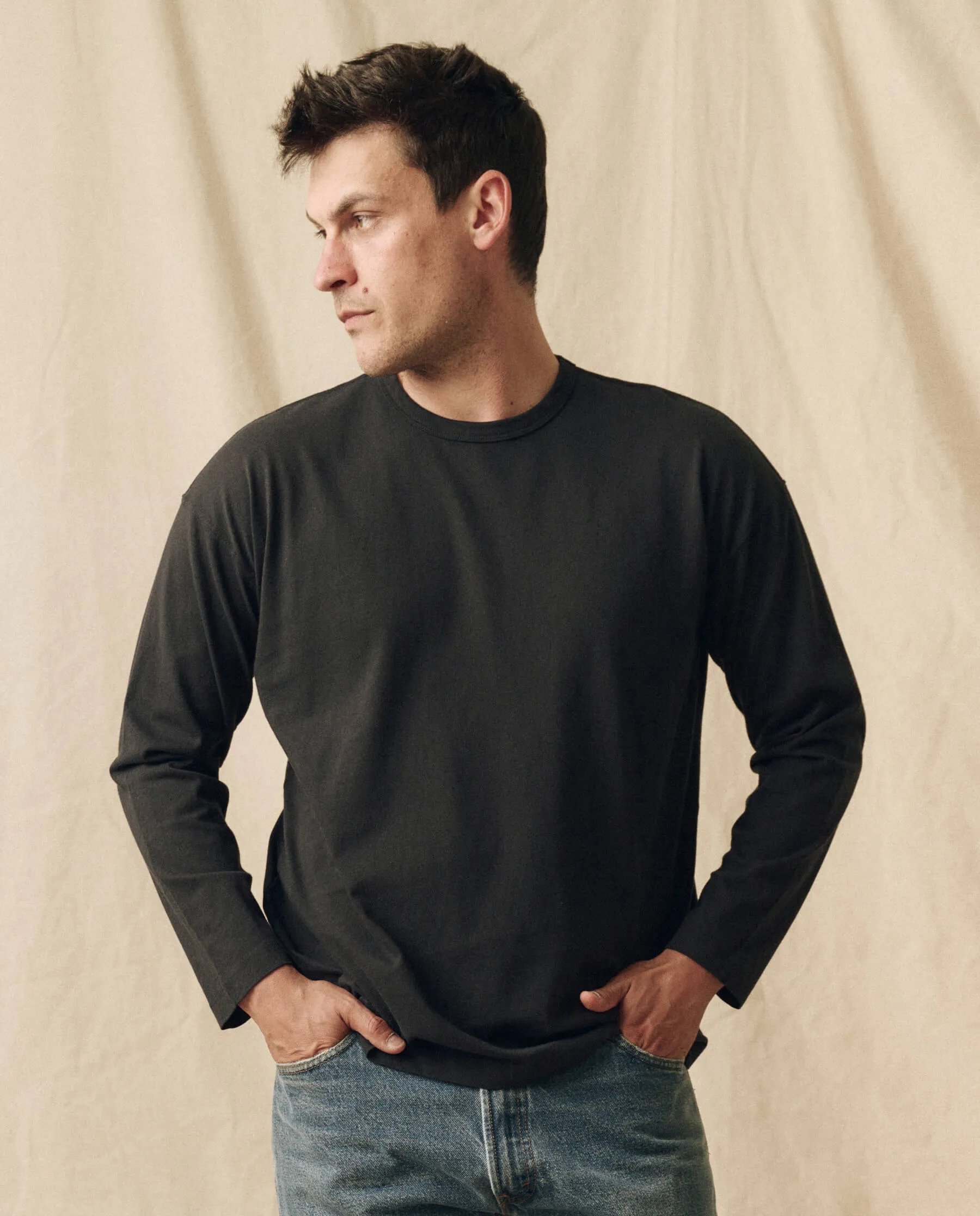 The Men's Pure Knits Long Sleeve Boxy Crew. Solid -- Almost Black sold by THE GREAT.