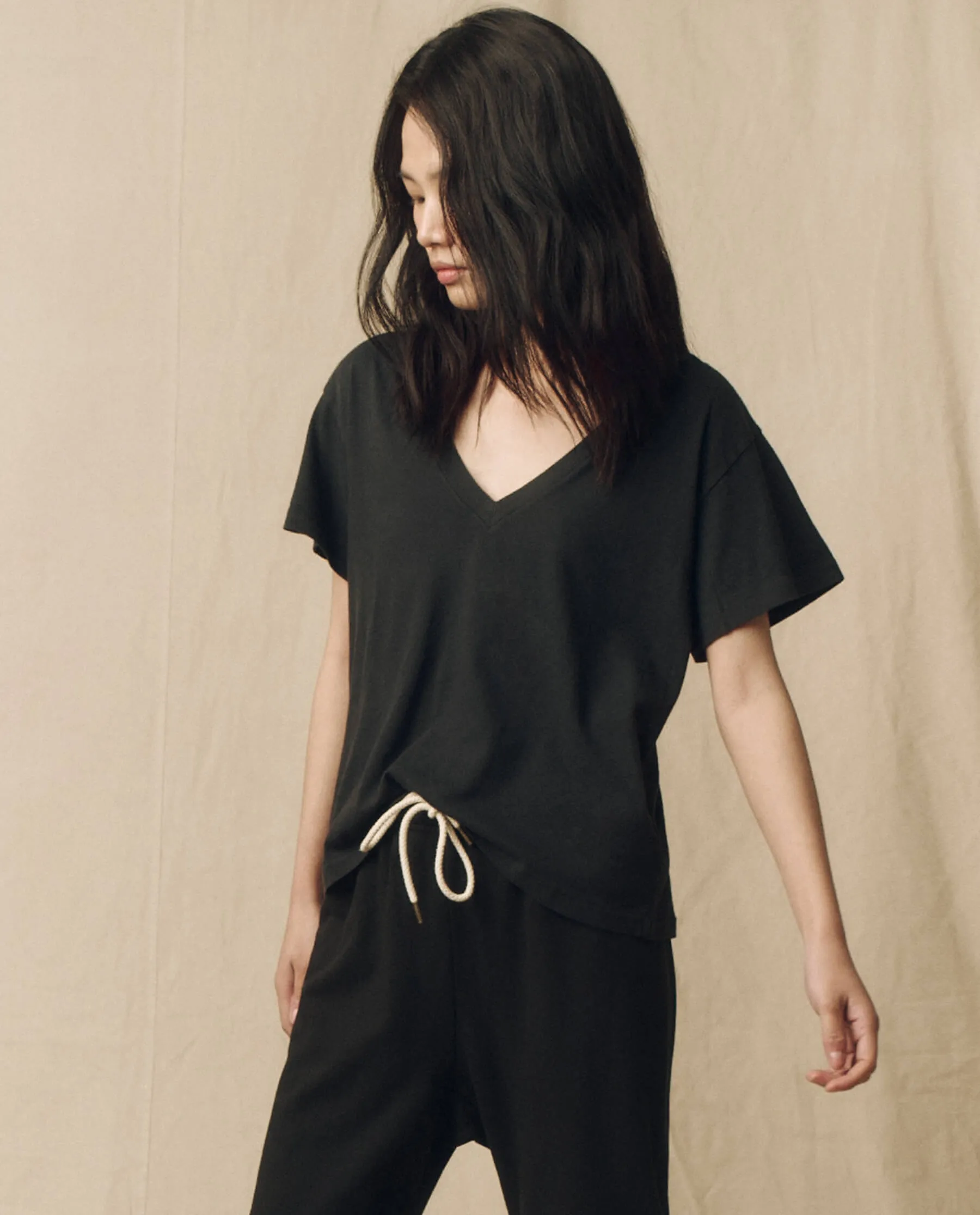 The V-Neck Tee. Solid -- Almost Black sold by THE GREAT.