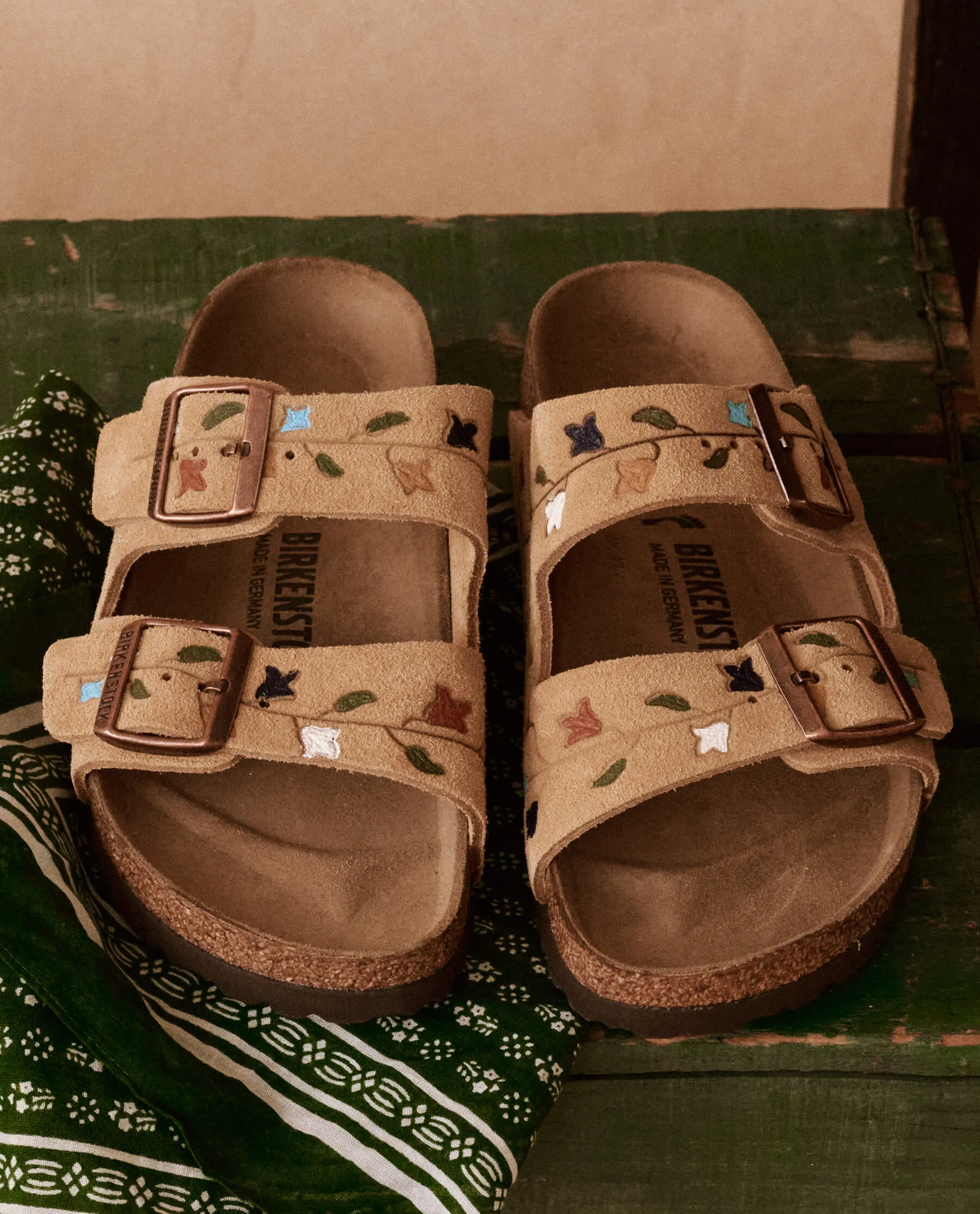 The BIRKENSTOCK Arizona with Hand Painted Tooled Tulip. -- Latte Cream with Multi sold by THE GREAT.