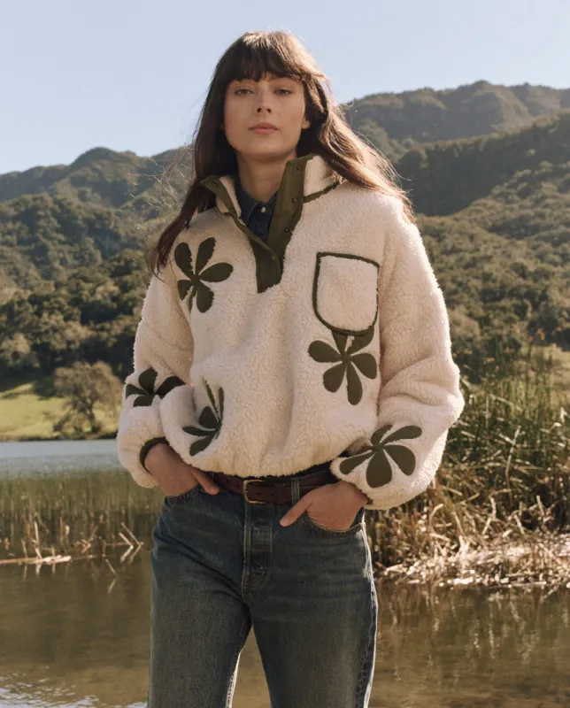 The Patch Pocket Countryside Pullover with Daisy Applique. -- Cream with Army sold by THE GREAT.