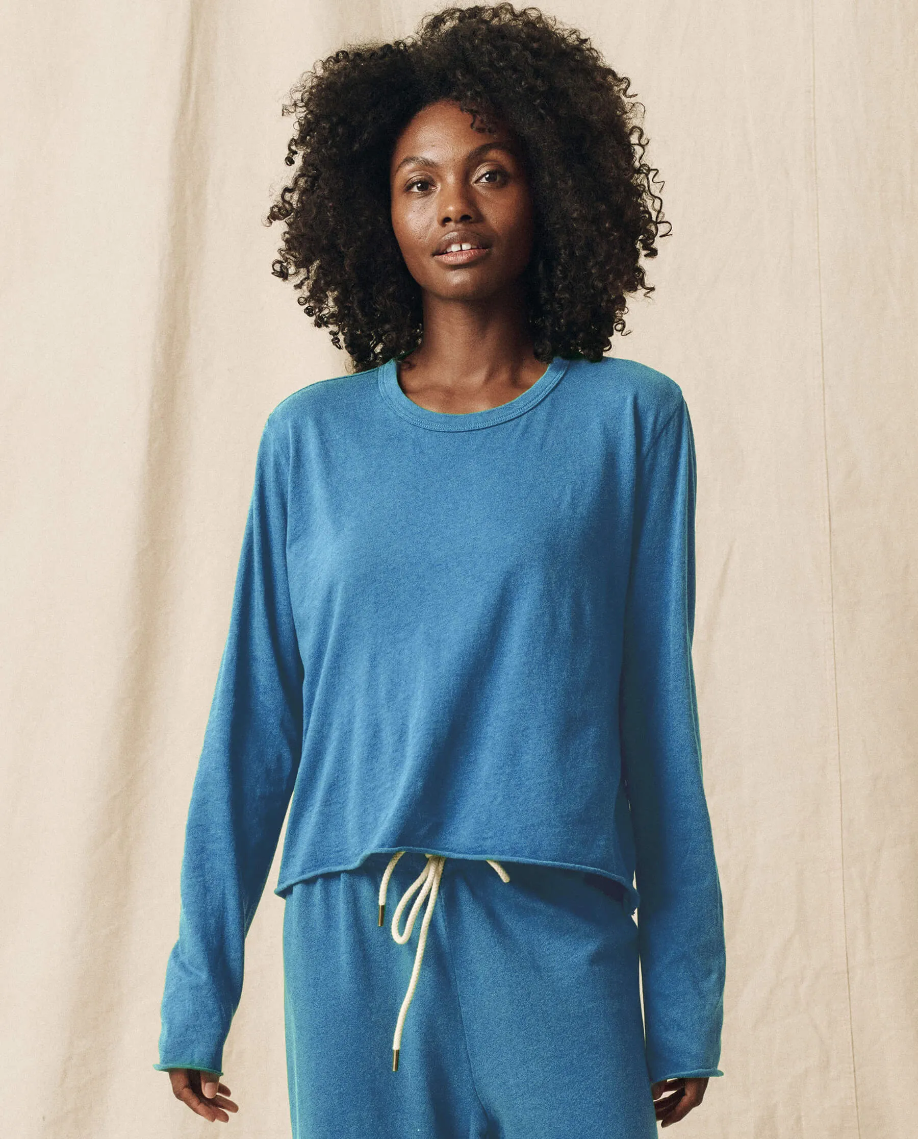 The Long Sleeve Crop Tee. Solid -- Glacier Blue sold by THE GREAT.