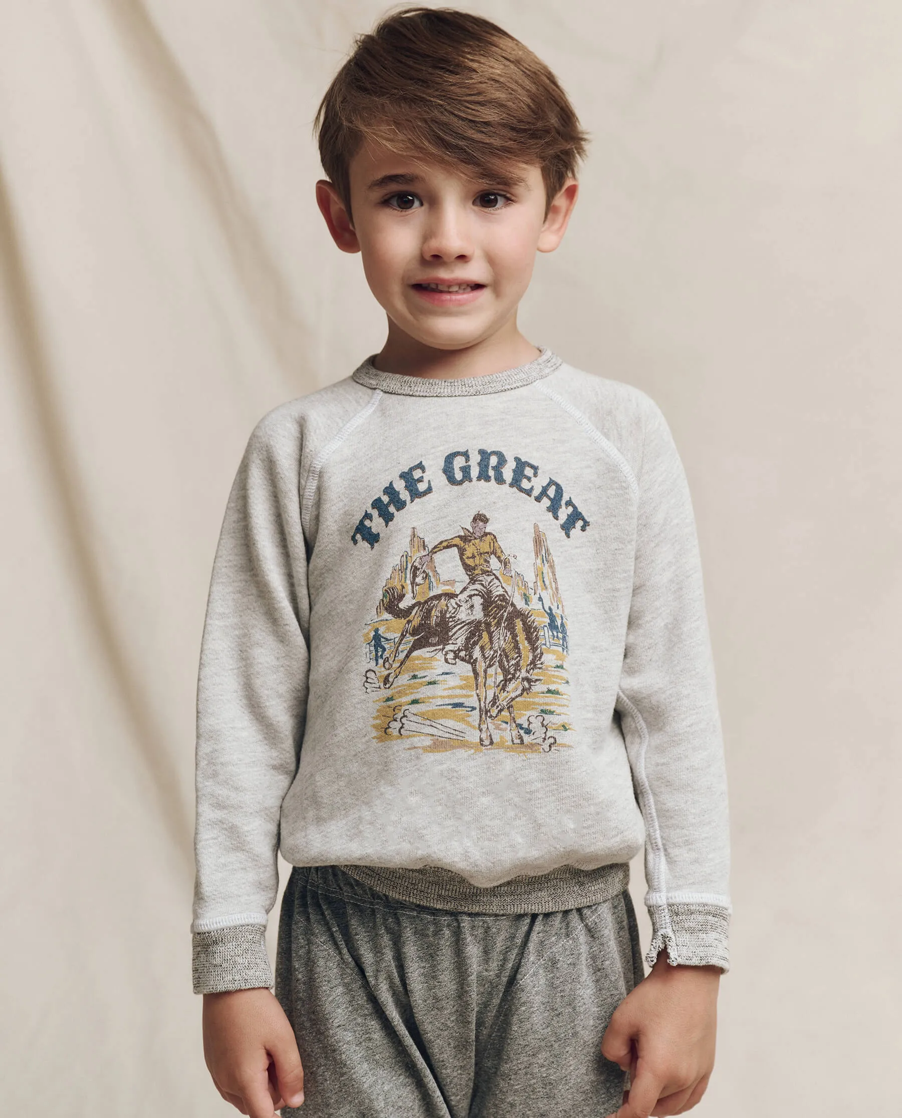 The Little College Sweatshirt. Graphic -- Soft Heather Grey with Rodeo Graphic sold by THE GREAT.