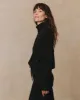 The Cashmere Turtleneck Sweater. -- Black sold by THE GREAT.