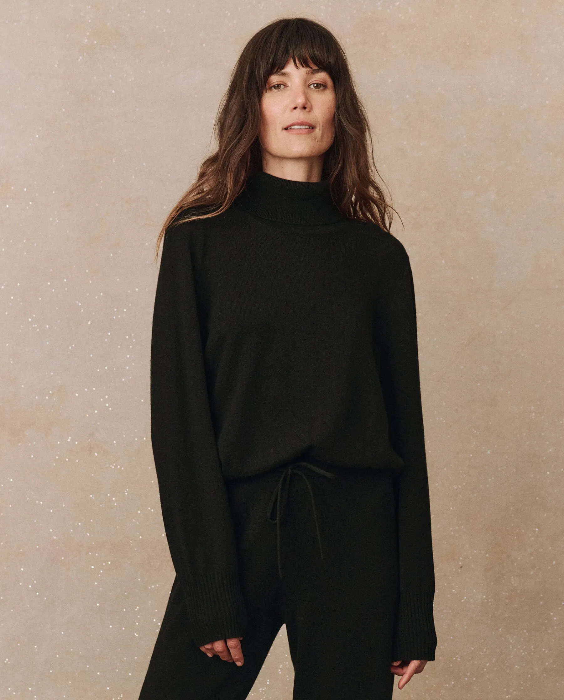 The Cashmere Turtleneck Sweater. -- Black sold by THE GREAT.