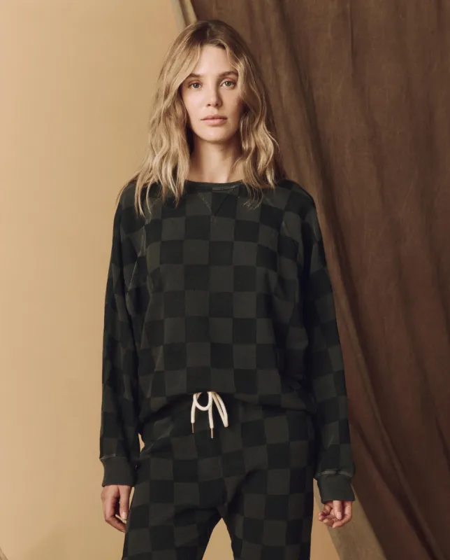 The Hand Stamped Slouch Sweatshirt. -- Washed Black with Black Check sold by THE GREAT.
