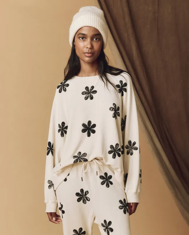 The Hand Stamped Slouch Sweatshirt. -- Washed White with Black Daisy made by THE GREAT.