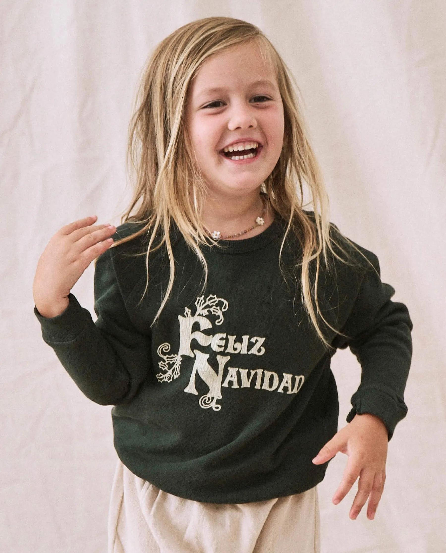 The Little College Sweatshirt. -- Dark Alpine with Feliz Navidad Graphic sold by THE GREAT.