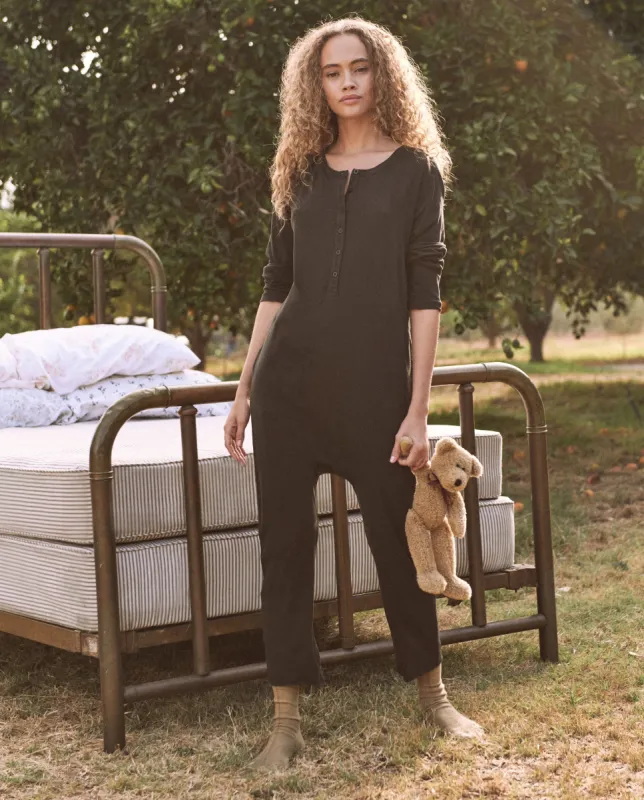 The Long Sleeve Sleeper Jumpsuit. -- ALMOST BLACK sold by THE GREAT.