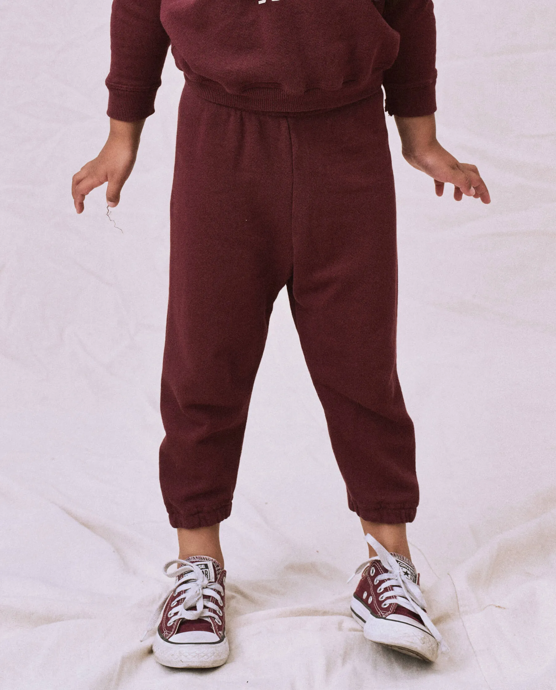 The Little Stadium Sweatpant. Solid -- Cherry Wood sold by THE GREAT.