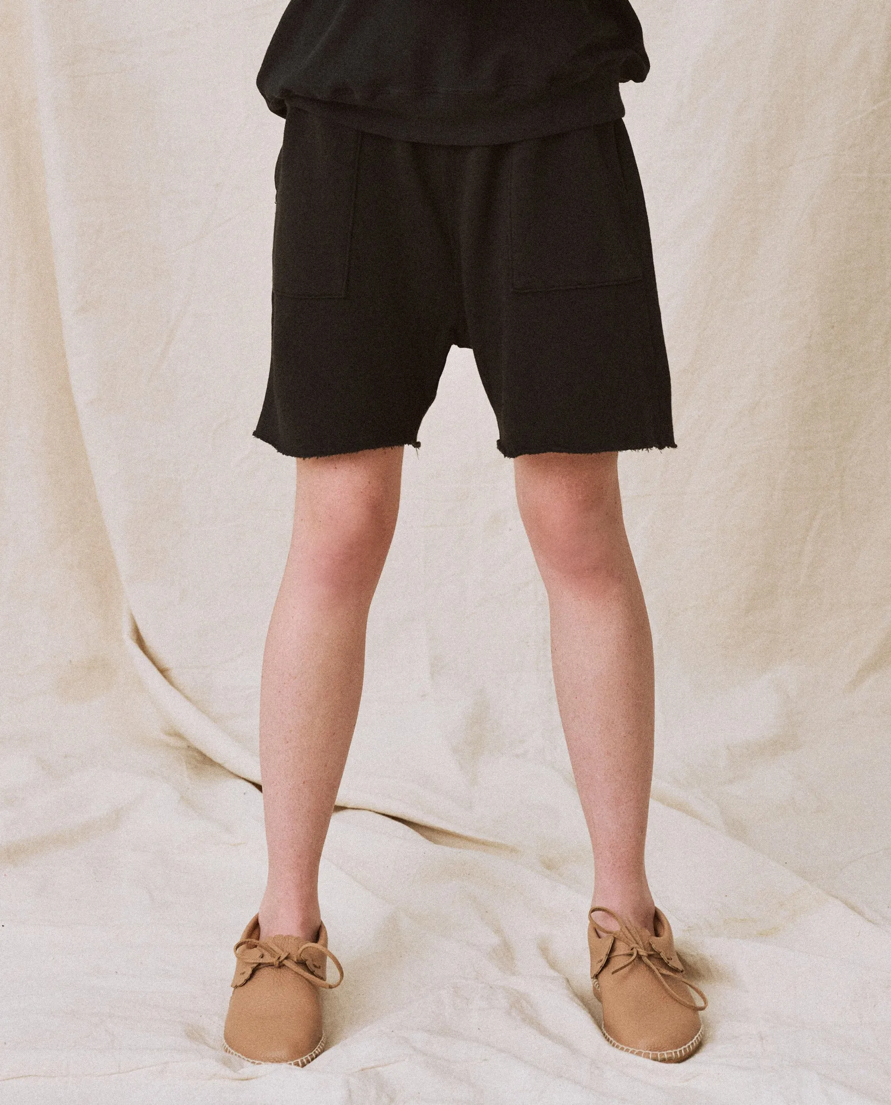The Patch Pocket Sweat Short. -- Almost Black sold by THE GREAT.