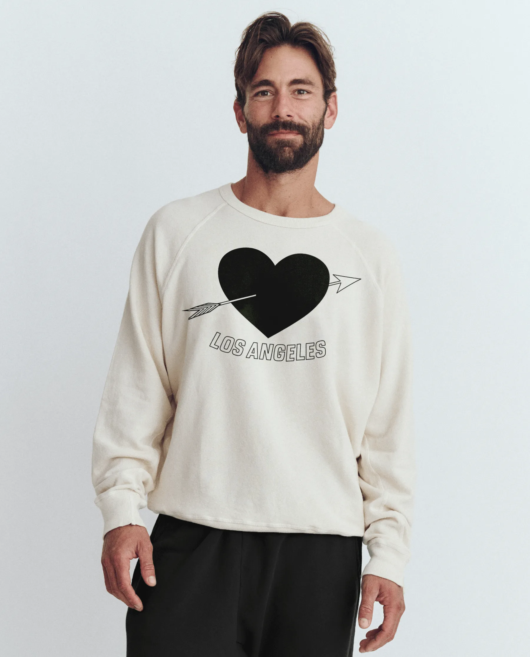 The Men's College Sweatshirt. Graphic -- Washed White with Los Angeles Heart Graphic sold by THE GREAT.