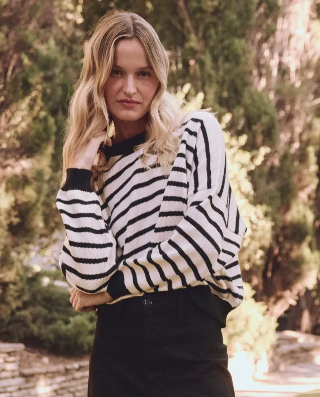 The Roll Neck Pullover. -- Black and Cream Stripe sold by THE GREAT.